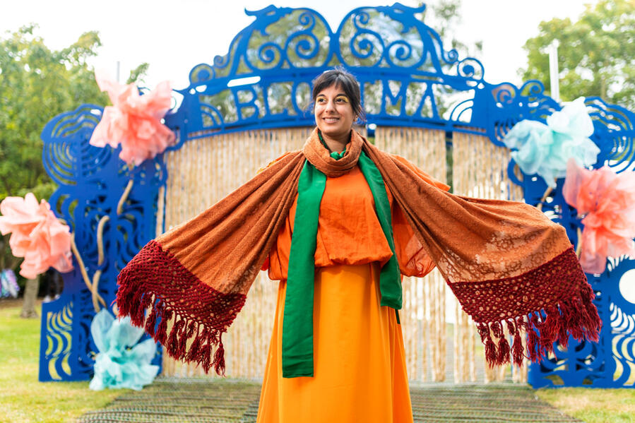 Colourful outdoor show, Michelle Kelly in bright orange dress with multiple scarves