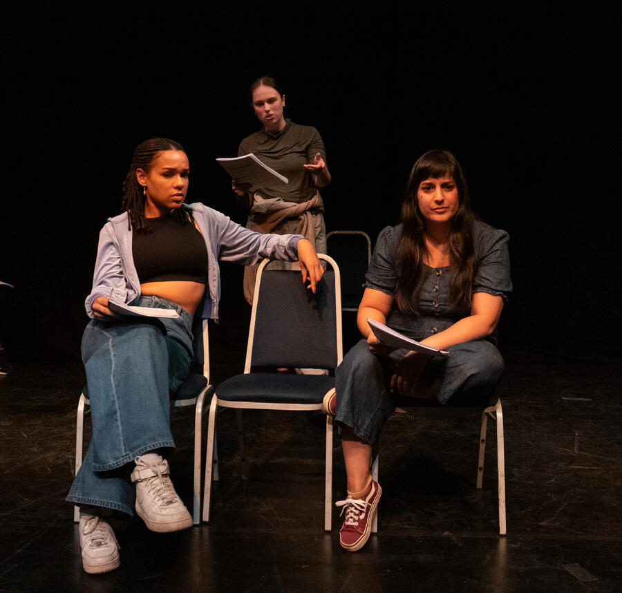 Stage photo of Michelle Kelly in period bridal gown, singing sadly