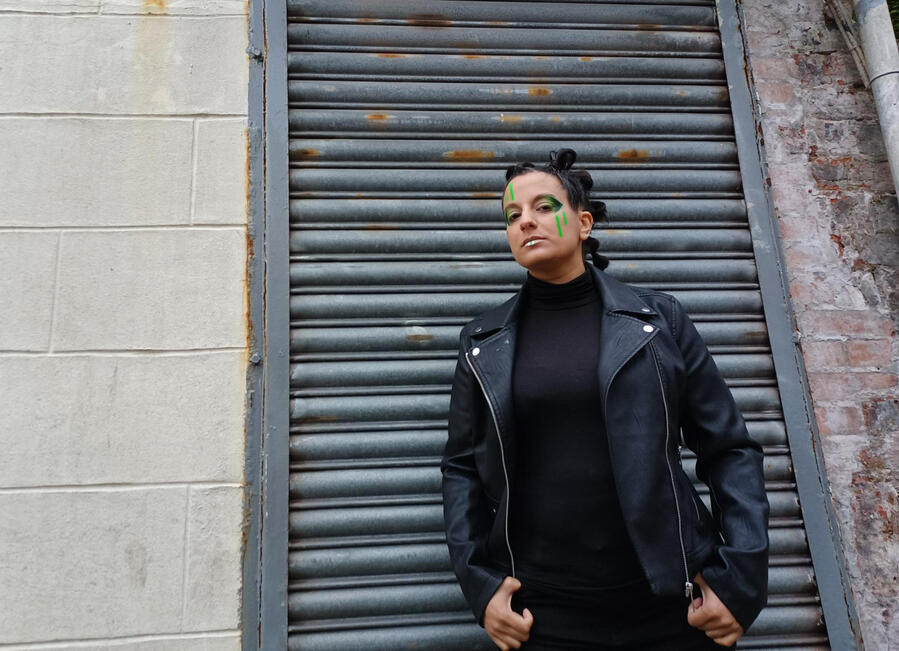 Promo shot of Michelle Kelly in black with cyberpunk-inspired hair and makeup